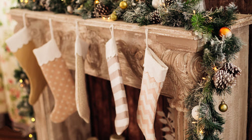 Minimalist holiday stockings filled with luxurious christmas gifts for holiday decor